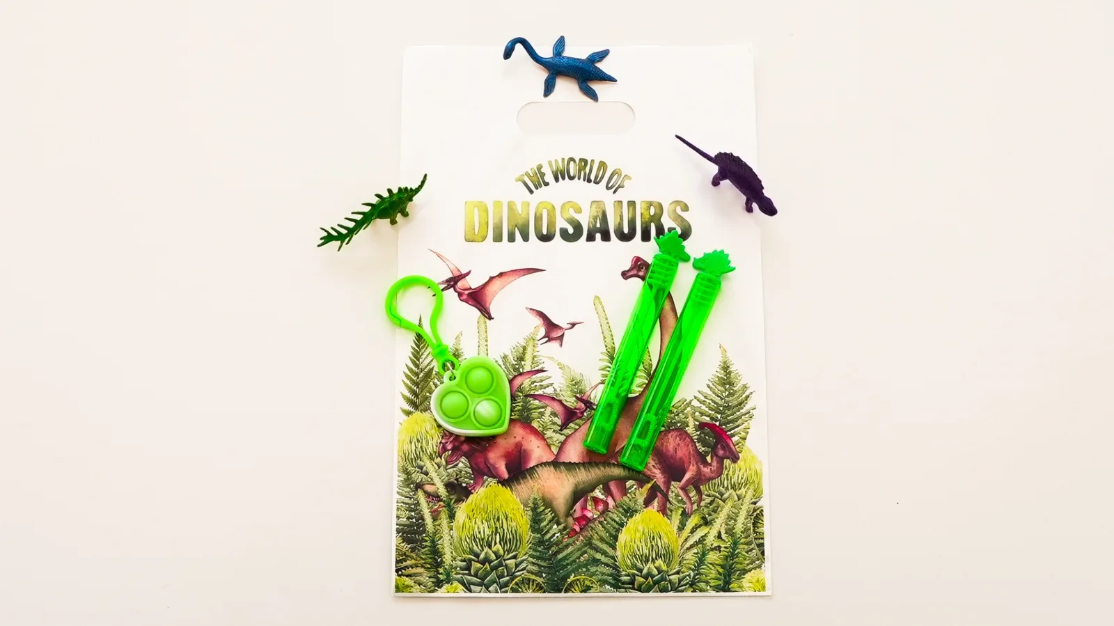 Pochette cadeau dinosaures avec figurines, bulles et pop-it pour anniversaire garçon